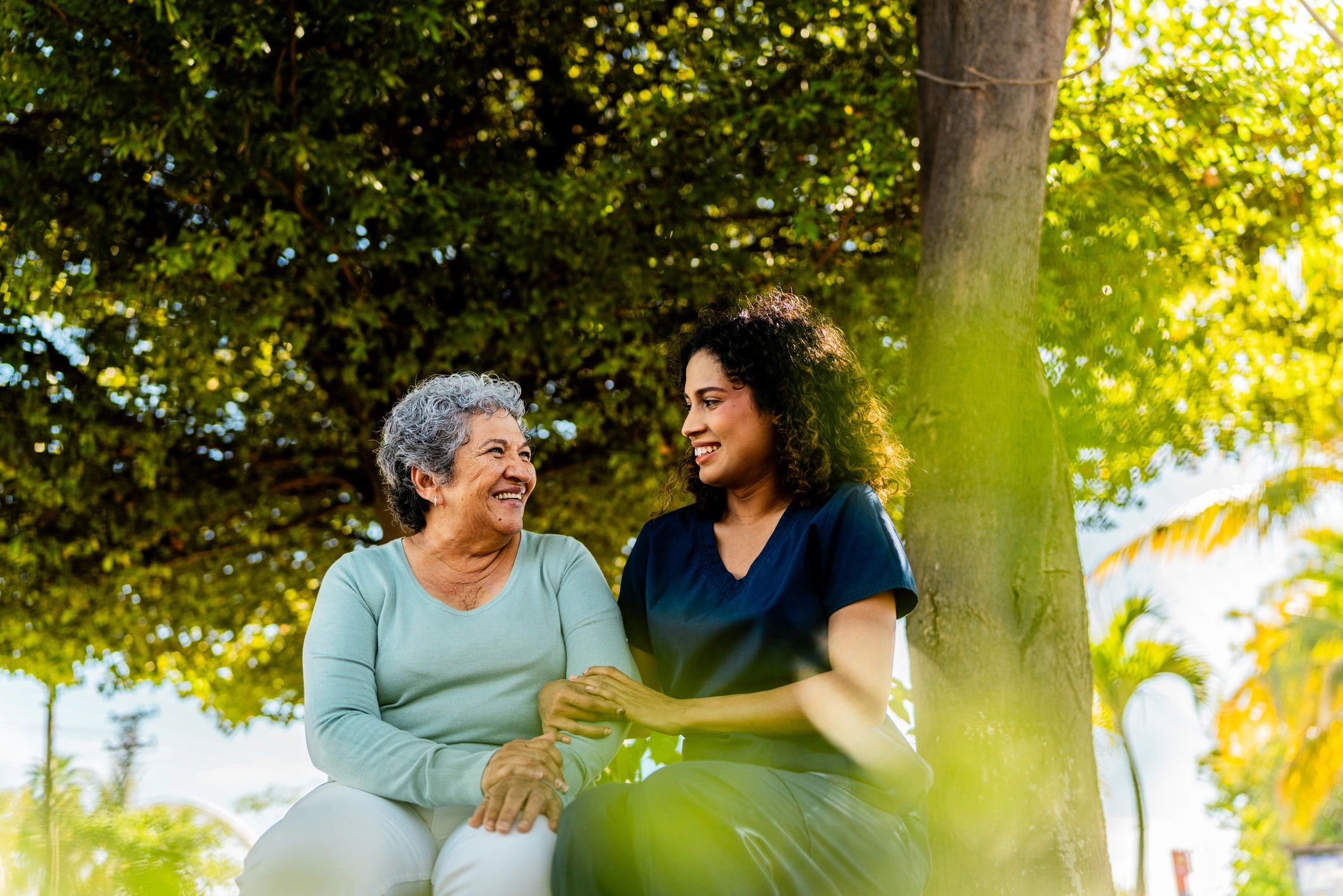 Caregiver supporting an older woman with friendly conversation