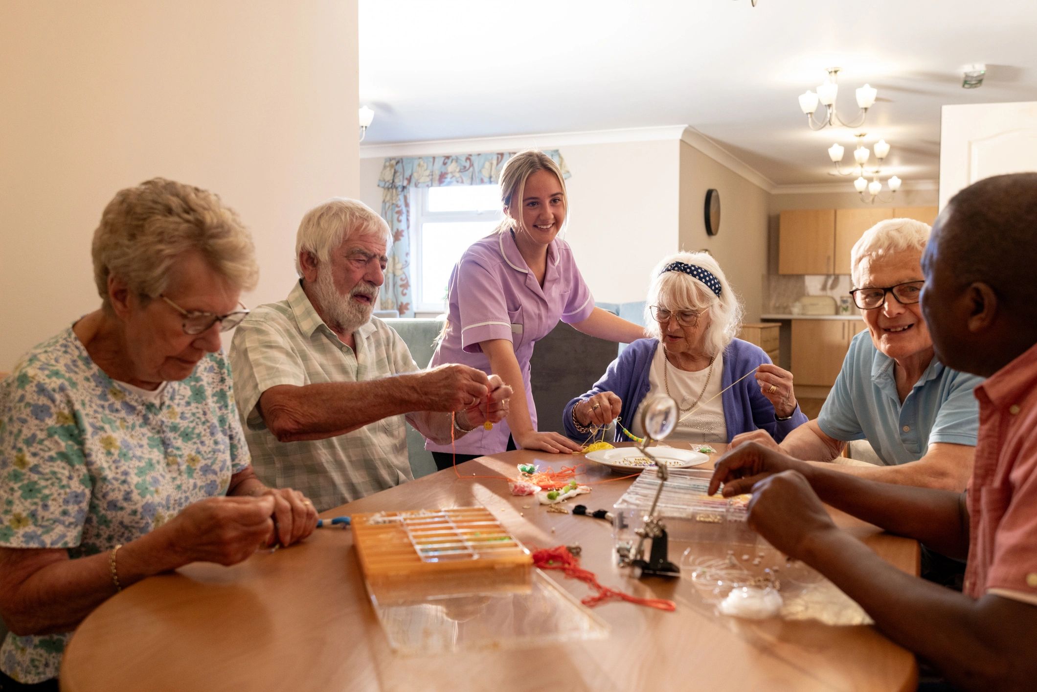 Residents enjoying a relaxed group activity in a bright, welcoming lounge